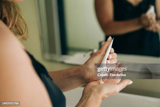 a beautiful middle-aged woman in a nightdress - sunscreen imagens e fotografias de stock