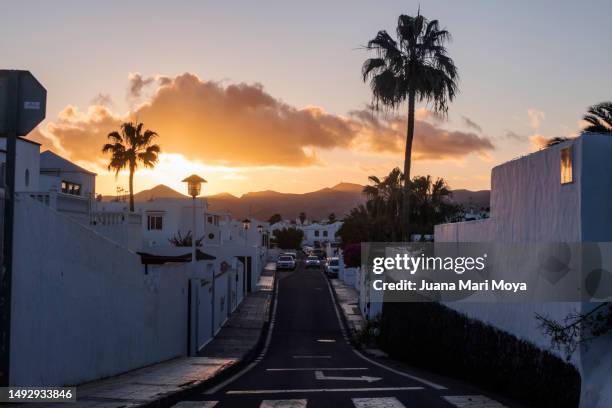 sunset in the town of puerto del carmen. lanzarote. canary islands - puerto del carmen fotografías e imágenes de stock