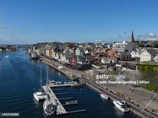high angle view of river amidst buildings in city,haugesund,norway - haugesund stock pictures, royalty-free photos & images