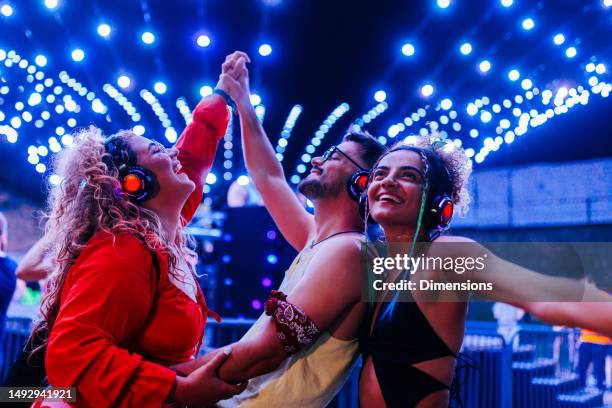 elated friends dance at dj performance - dj images free stock pictures, royalty-free photos & images