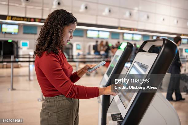 check in at airport - red plane stock pictures, royalty-free photos & images