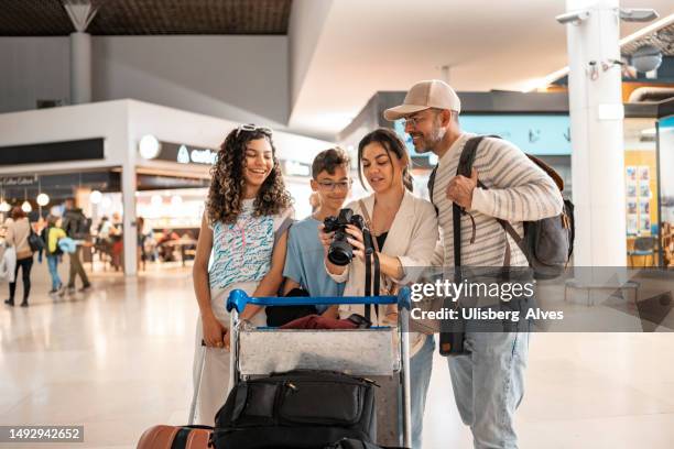 tourist group at airport - travel insurance stock pictures, royalty-free photos & images