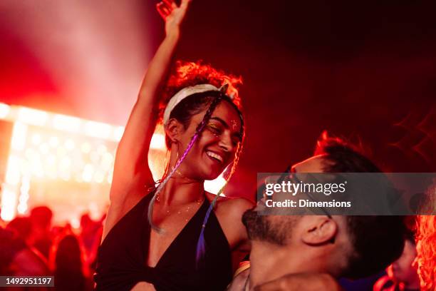 cute couple at concert having fun - music festival dancing stock pictures, royalty-free photos & images