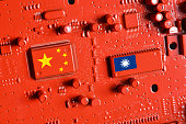 Flag of the Republic of China and Taiwan on the chips of a red painted printed electronic circuit board. Concept for supremacy in global microchip and semiconductor manufacturing.