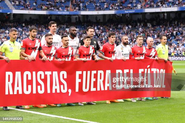 Players from both teams and match officials pose for a photo with a banner against racism prior to the LaLiga Santander match between Real Madrid CF...