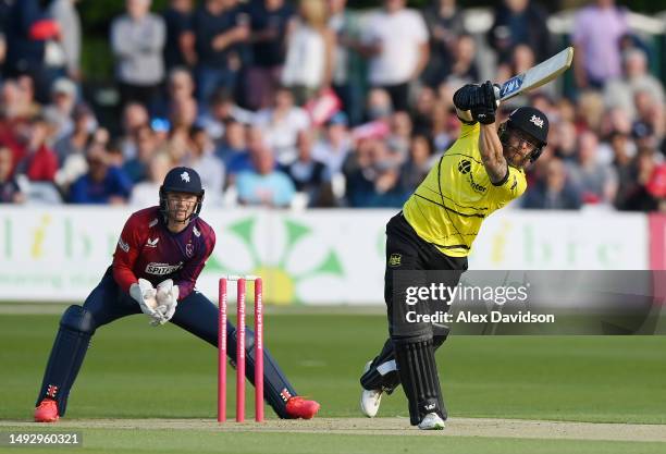 Chris Dent of Gloucestershire hits out watched on by Sam Billings of Kent during the Vitality Blast T20 match between Kent Spitfires and...