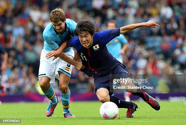 Kensuke Nagai of Japan clashes with Inigo Martinez of Spain during the Men's Football first round Group D Match of the London 2012 Olympic Games...