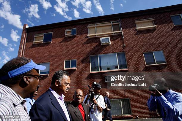Civil rights activist Reverend Jesse Jackson walks outside of the apartment building where accused murderer James Holmes lived before speaking to...