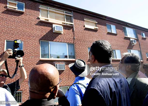 Rights activist Reverend Jesse Jackson looks at the apartment building where accused murderer James Holmes lived before speaking to reporters July...