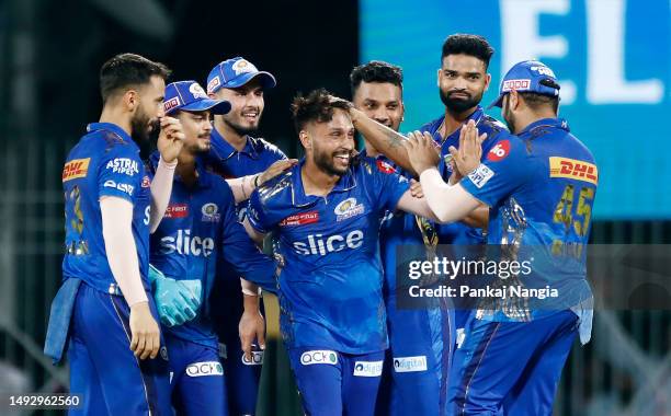 Akash Madhwal of Mumbai Indians celebrates with teammates after bowling out Mohsin Khan of Lucknow Super Giants during the IPL Eliminator match...