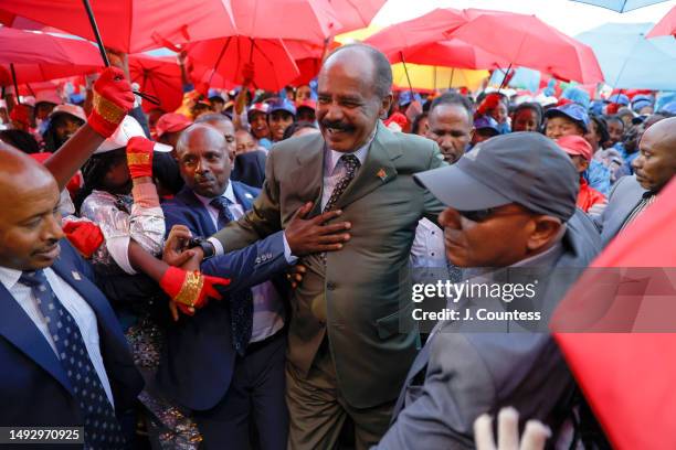Eritrean President Isaias Afewerki greets attendees during the official 32nd Anniversary of Independence celebration at Asmara Stadium on May 24,...