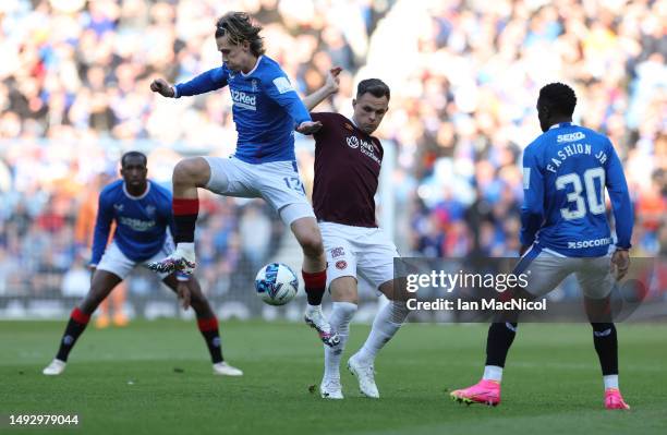 Todd Cantwell of Rangers vies with Lawrence Shankland of Hearts during the Cinch Scottish Premiership match between Rangers and Heart of Midlothian...