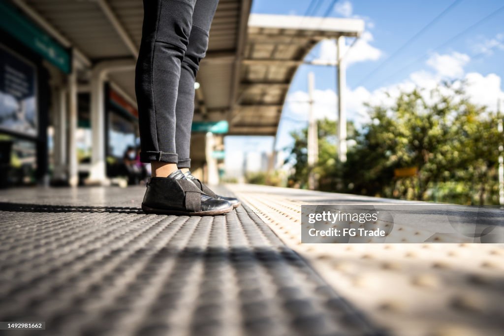 Woman's legs on a train station platform