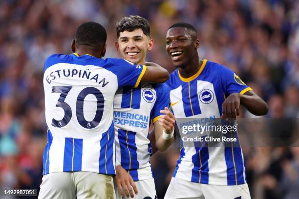 Julio Enciso of Brighton & Hove Albion celebrates with teammates Pervis Estupinan and Moises Caicedo of Brighton & Hove Albion after scoring the...