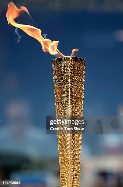 The Olympic Torch is seen in detail as a torch bearer carrries the Olympic Torch through Central London on July 26, 2012 in London, England.