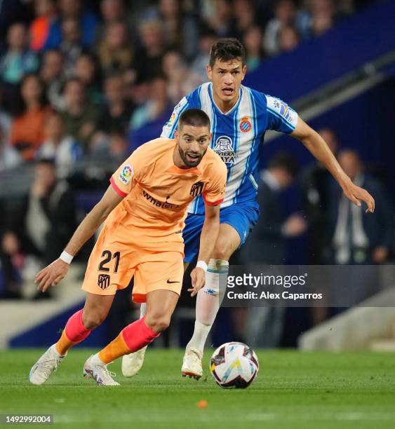 Yannick Ferreira Carrasco of Atletico Madrid battles for possession with Cesar Montes of RCD Espanyol during the LaLiga Santander match between RCD...
