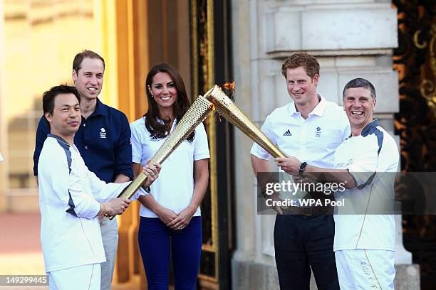 Prince William, Duke of Cambridge, Catherine, Duchess of Cambridge and Prince Harry watch Wai-Ming hand over the London 2012 Olympic Torch to John...