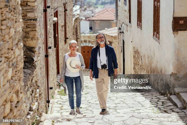 coppia matura che visita il vecchio villaggio di lefkara, cipro - cypriot culture foto e immagini stock