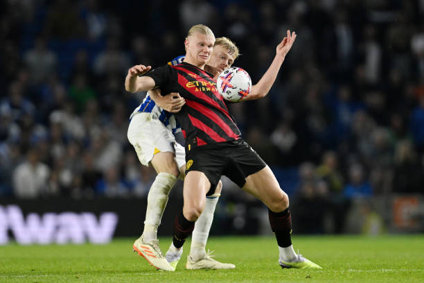Erling Haaland of Manchester City battles for possession with Jan Paul van Hecke of Brighton & Hove Albion during the Premier League match between...