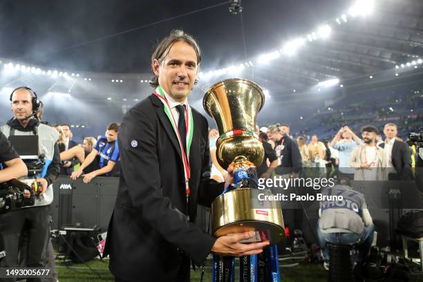 Simone Inzaghi, Head Coach of FC Internazionale, poses for a photograph with the Coppa Italia trophy after their side's victory in the Coppa Italia...