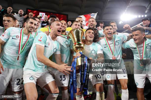 Lautaro Martinez of FC Internazionale celebrates with the Coppa Italia trophy with team mates after their side's victory in the Coppa Italia Final...