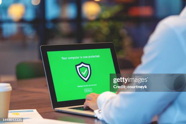 businessman looking at a antivirus security log in screen on a computer - antivirus stock pictures, royalty-free photos & images