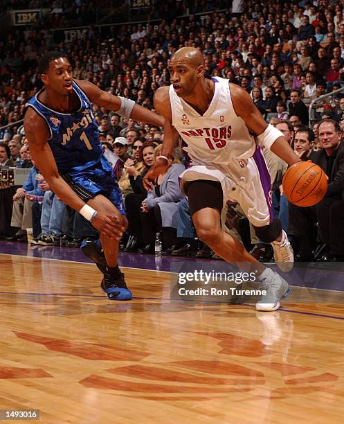 Vince Carter of the Toronto Raptors looks to drive around his cousin Tracy McGrady of the Orlando Magic at Air Canada Centre in Toronto, Canada....