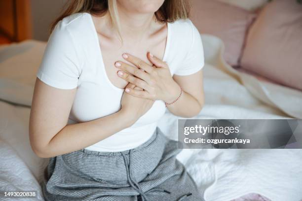 heart attack, women with chest pain suffering at home - cardiac arrhythmia stock pictures, royalty-free photos & images