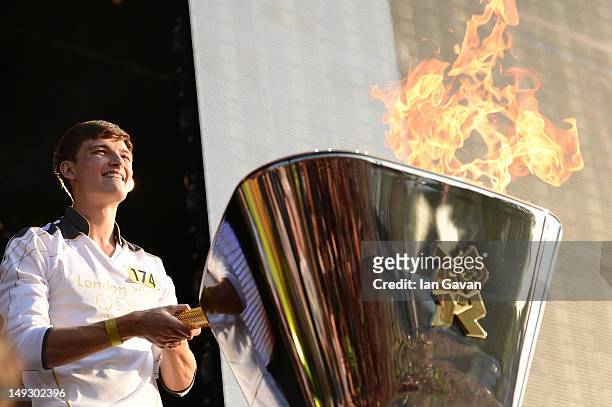 Future Flame Tyler Rix lights the Olympic cauldron during the London 2012 Olympic Torch Relay Finale Concert in London's Hyde Park, presented by...