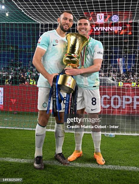 Robin Gosens and Stefan De Vrij of FC Internazionale celebrate the win with the trophy during the award ceremony at the end of the Coppa Italia final...