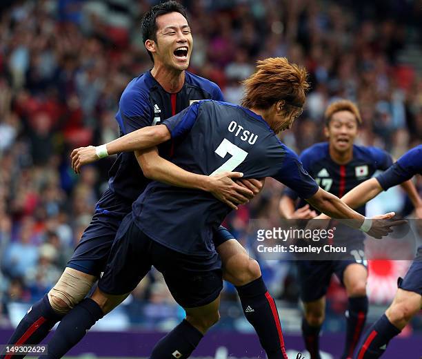 Yuki Otsu and Maya Yoshida of Japan celebrates during the Men's Football first round Group D Match of the London 2012 Olympic Games between Spain and...