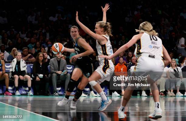 Sabrina Ionescu of the New York Liberty in action against Kristi Wallace and Lexie Hull of the Indiana Fever at Barclays Center on May 21, 2023 in...