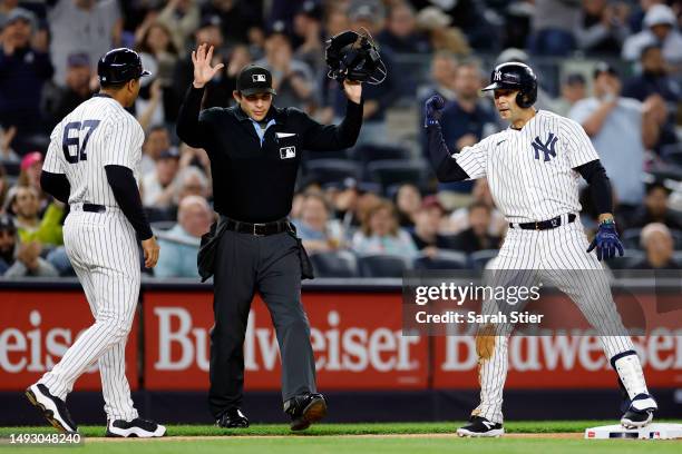 Isiah Kiner-Falefa reacts with third base coach Luis Rojas of the New York Yankees after hitting a triple during the third inning against the...