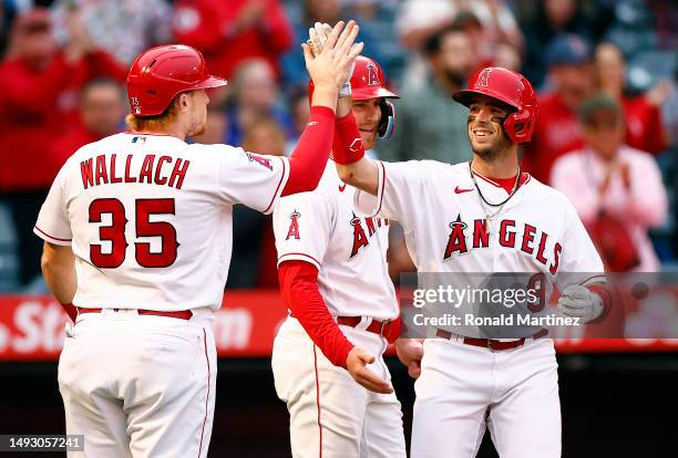 Zach Neto of the Los Angeles Angels celebrates a three-run home run with Chad Wallach and Brandon Drury in the second inning against the Boston Red...