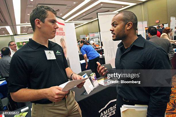 Ryan Field, a representative at Anderson Pest Control, left, talks with job seeker Arnold Neely during the Hiring Our Heroes veteran job and career...