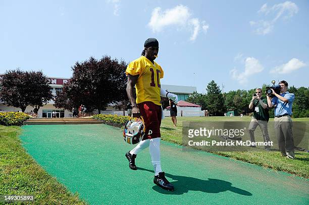 Robert Griffin III of the Washington Redskins walks onto the field during training camp at Redskins Park on July 26, 2012 in Ashburn, Virginia.
