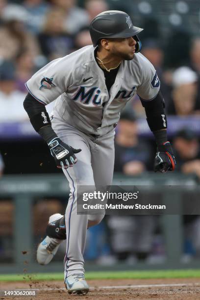 Yuli Gurriel of the Miami Marlins hits a RBI single against the Colorado Rockies in the fourth inning at Coors Field on May 24, 2023 in Denver,...