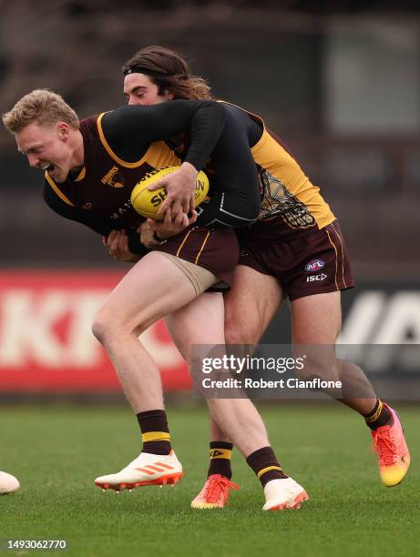 James Sicily of the Hawks is challenged by Jai Newcombe of the Hawks during a Hawthorn Hawks AFL training session at Waverley Park on May 25, 2023 in...