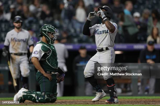 Jonathan Davis of the Miami Marlins gestures as he crosses home plate after hitting a solo home run against the Colorado Rockies in the sixth inning...