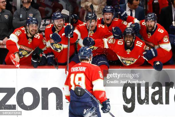 Matthew Tkachuk of the Florida Panthers celebrates with his teammates after scoring the game winning goal on Frederik Andersen of the Carolina...