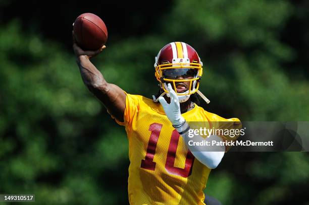 Robert Griffin III of the Washington Redskins throws a pass during training camp at Redskins Park on July 26, 2012 in Ashburn, Virginia.