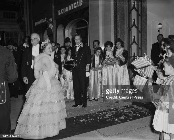 Elizabeth the Queen Mother arrives at Claridge's Hotel greeted by children waving flags ahead of a dinner given by the King and Queen of Greece,...