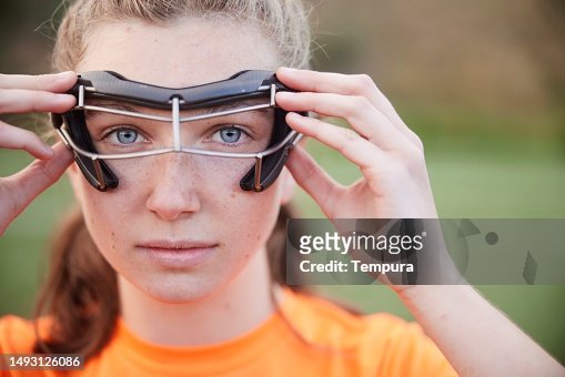 Focused Gaze: Intense Close-Up of Lacrosse Female Player with Protective Glasses