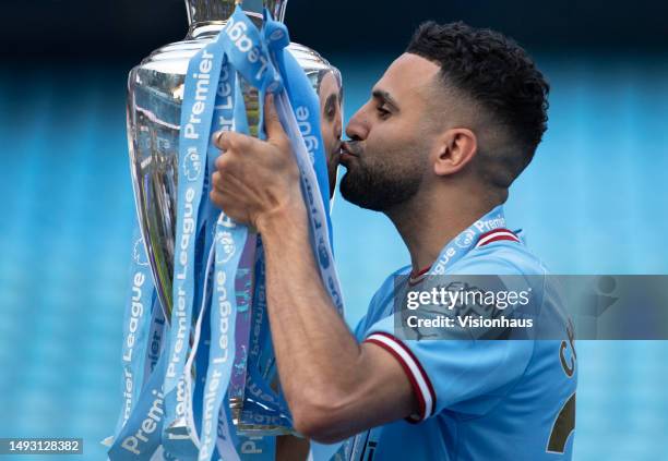 Riyad Mahrez of Manchester City kisses the Premier League trophy after during the Premier League match between Manchester City and Chelsea FC at...