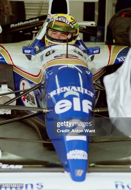 Ayrton Senna from Brazil looks out from the cockpit of the Rothmans Williams Renault Williams FW16 Renault V10 in the garage before the start of the...