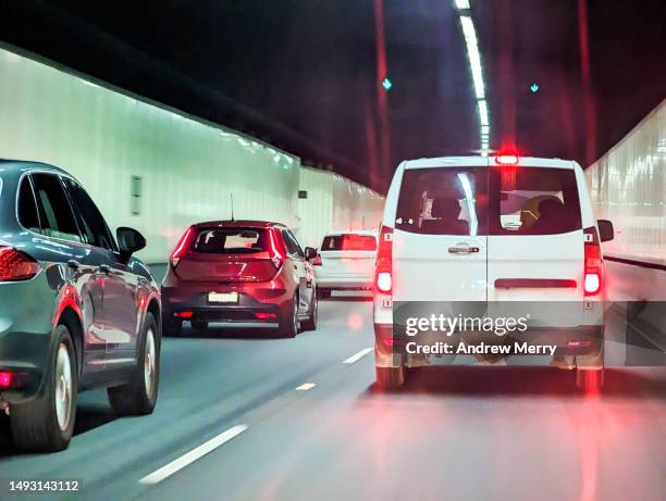 traffic in road tunnel, van cars, highway - dashboard camera point of view stock pictures, royalty-free photos & images