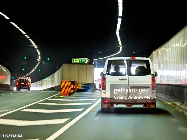 van driving leaving road tunnel traffic - barrera de seguridad raya indicadora fotografías e imágenes de stock