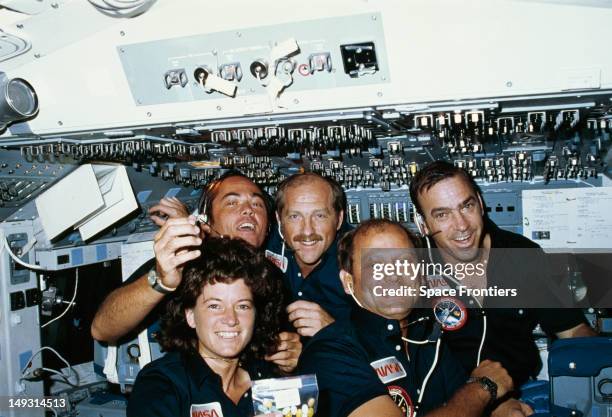 The crew of NASA's STS-7 space mission in space, June 1983. From left to right, they are Robert L. Crippen, Frederick H. Hauck and John M. Fabian;...