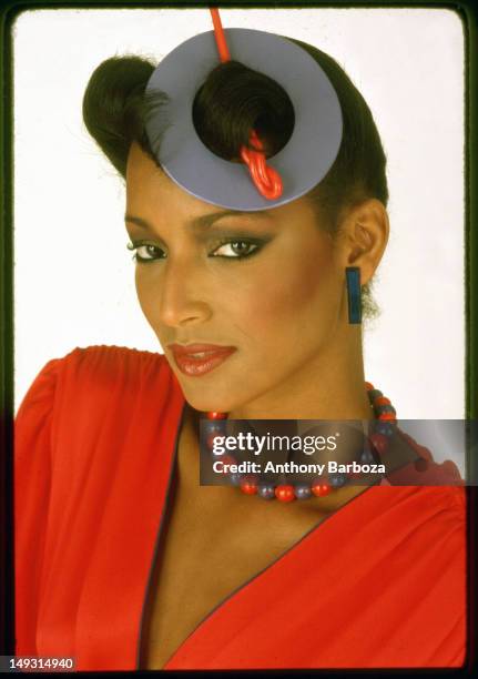 Portrait of model Sheila Johnson as she poses in red against a white background, 1979. The picture was part of a photo shoot for Essence magazine.