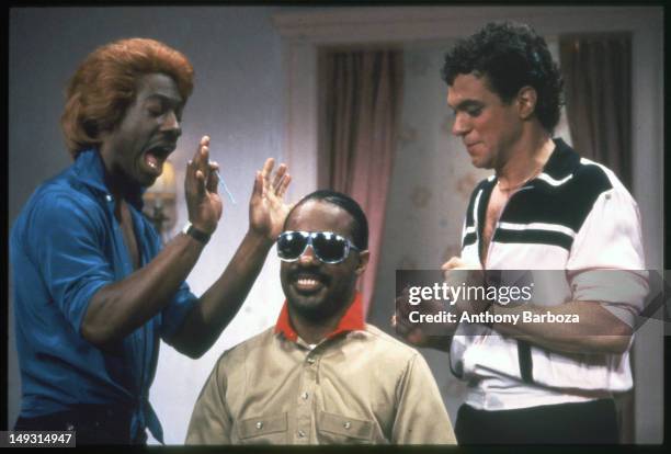 American comedians Eddie Murphy , in costume as the character Dion, and Joe Piscopo , in costume as the character Blaine, perform a skit with...